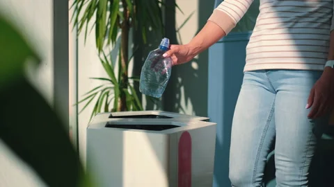 Close-up. A person throws a plastic bottle into a waste sorting container. Stock Footage 236902443
