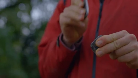 Close Up of Person Tries to start a Fire with a Stone in the Nature  Видео 122333368