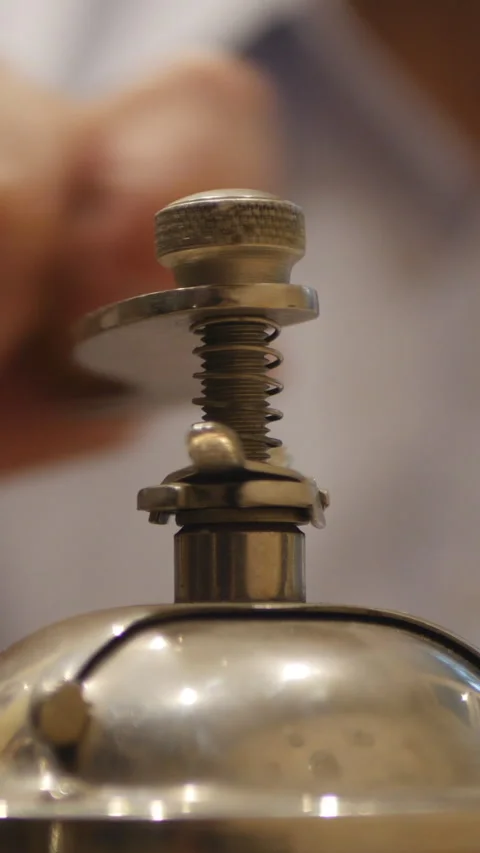 Close-Up Of A Person Turning The Handle Of A Vintage Coffee Grinder. Vertical. Video stock 303482853