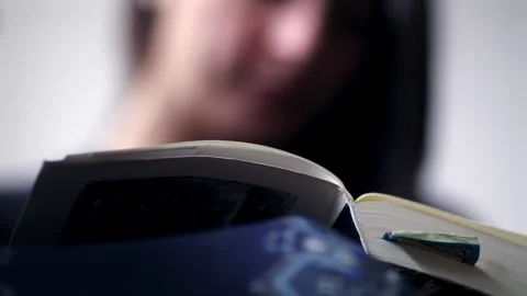Close-up of a person turning pages of an open book, highlighting the moveme.. Stock Footage 287247234