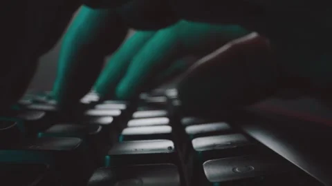 Close up of person typing fast on backlit mechanical computer keyboard in d.. Video stock 337543170