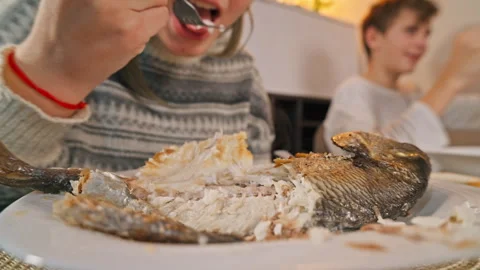 Close up of person use fork to separate meat of fish on white plate, enjoy .. Stock Footage 327164085