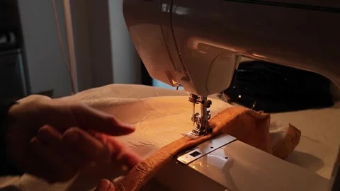 Close-up of a person using fabric on a home sewing machine, emphasizing Video stock 281576817