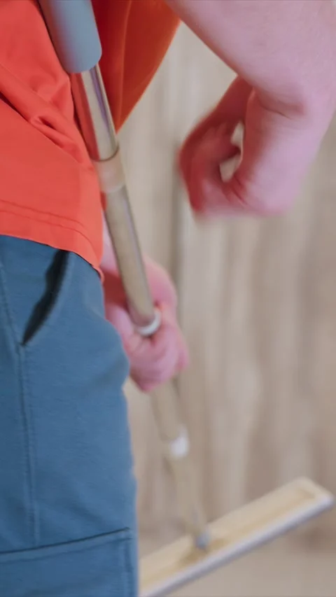 Close up of person using floor mop in domestic setting showing cleaning tool Stock Footage 346787377