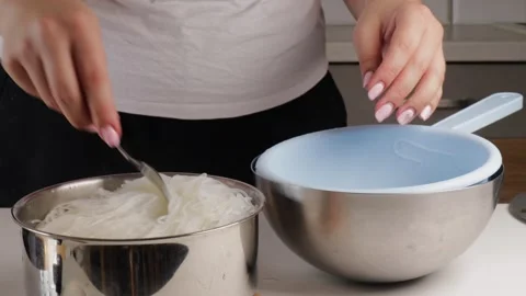 Close-up of person using fork to transfer boiled rice noodles into strainer bowl Video stock 317107829