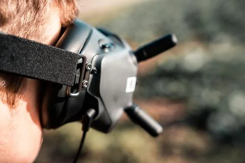Close up of a person using the fpv goggles for a dji drone 写真素材
