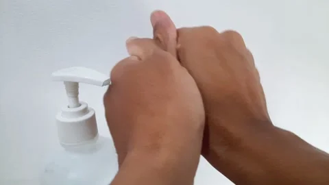 Close-up of a person using hand sanitizer gel Stock Footage 222575650