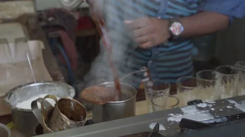 Close up of a person using a hot kettle to pouring the tea  Video stock 144796794