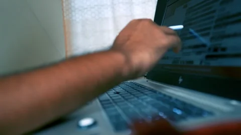 Close-up of a person using a laptop with a stylus, focusing on the hand and.. Stock Footage 315982655