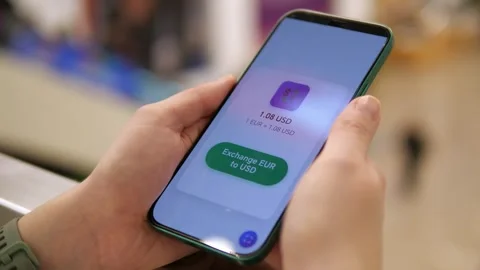 Close-up of a person using a mobile fintech app for currency exchange. Video stock 327319737