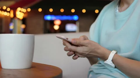 Close up of person using the phone on a coffee break in a café Stock Footage 140935755