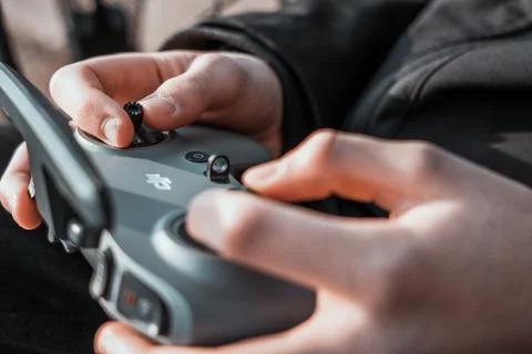 Close up of a person using a remote control for a dji drone 写真素材