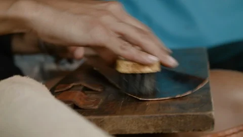 Close up of person using scrubbing brush on leather, Ecuador Stock Footage 143014805