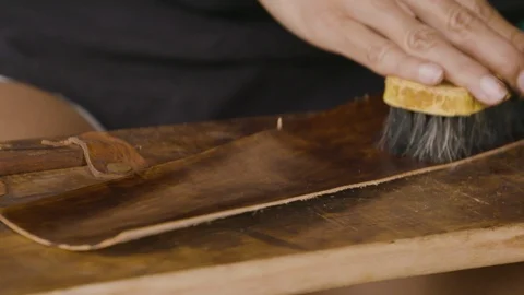 Close up of person using scrubbing brush on leather, Ecuador Vídeos de archivo 143015781