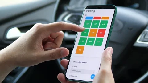 Close-up of a person using a smart parking app to reserve a space. Stock Footage 327389906