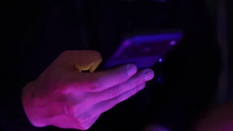 Close-up of person using smartphone and scrolling on mobile screen with Stock Footage 336888706