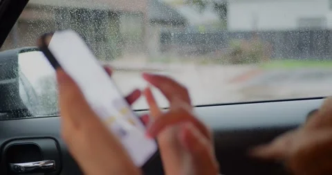 Close-up of person using a smartphone inside a car, tapping... Stock Footage 319882213