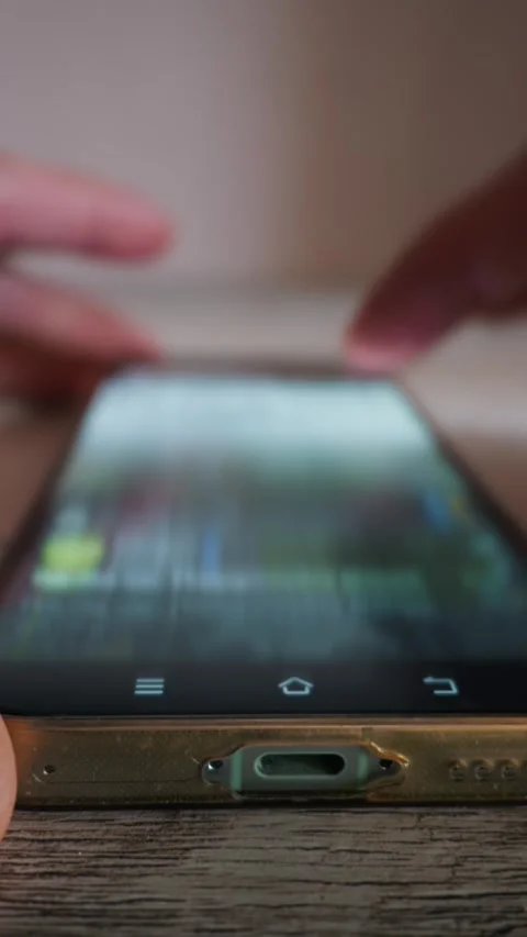 Close Up of Person Using Smartphone Resting on Wooden Table in Vertical View Stock Footage 339208682
