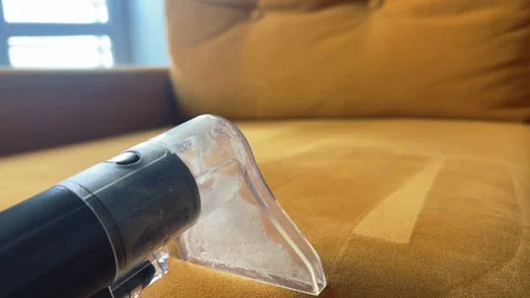A close-up of a person using a special washing vacuum cleaner to deep clean.. Stock Footage 345834590