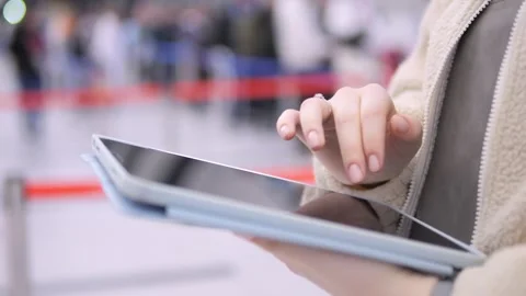 Close-up of person using tablet at busy airport Stock Footage 346174449