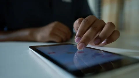 Close-up of a person using a tablet with a finger on the screen Stock Footage 317737018