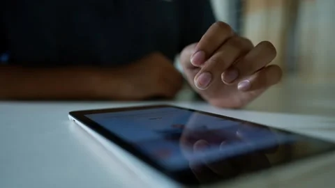 Close-up of a person using a tablet on a table Stock Footage 318578331