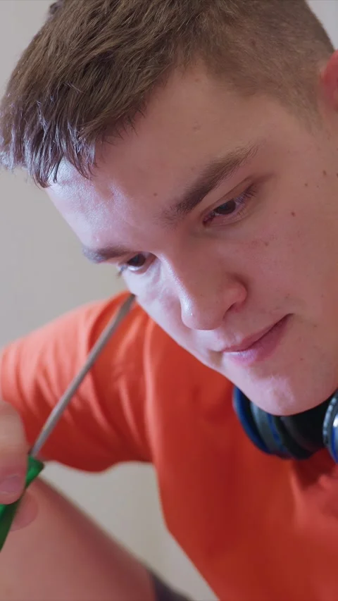Close up of person working with green handled screwdriver in orange shirt and Stock Footage 346787009