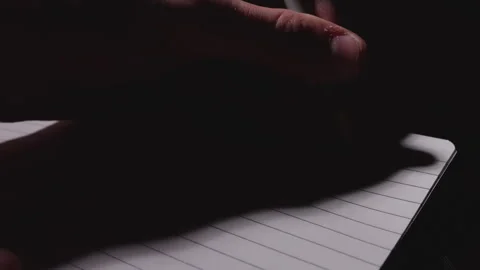Close up of a person writing down a list on a notebook 動画素材 332728742