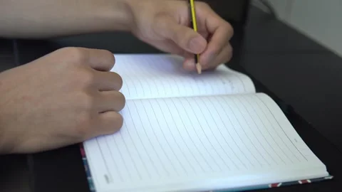 Close Up of Person Writing in Notebook with Pencil Stock Footage 341707143