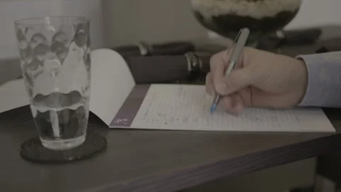 Close-Up of Person Writing Notes and Sketching on Paper Stock Footage 344603827