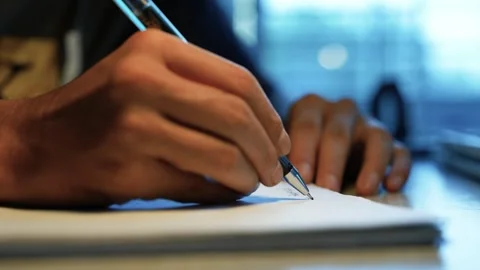 Close Up of Person Writing on Paper, Close-up of a person writing with a pe.. Stock Footage 346483886