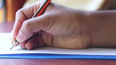Close Up Of a Person Writing On a Paper Stock Footage 170154448