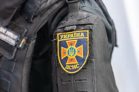Close-up of a persons arm wearing a jacket with an emblem patch, featuring a  Stock Photos