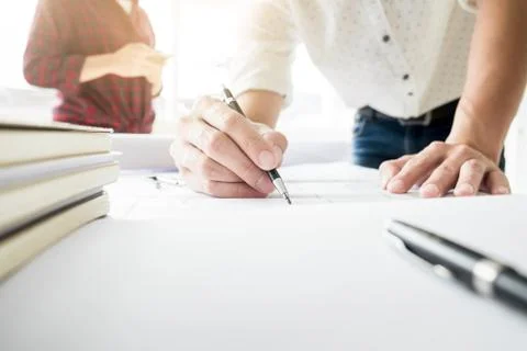 Close-up Of Person's engineer Hand Drawing Plan On Blue Print Fotos de archivo
