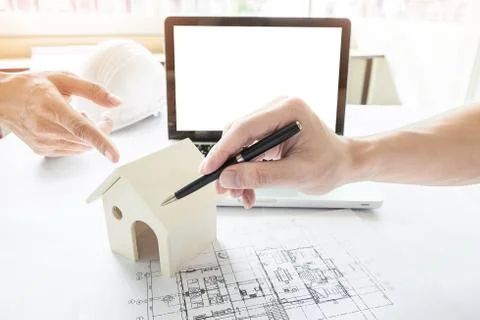 Close-up Of Person's engineer Hand Drawing Plan On Blue Print Fotos de archivo