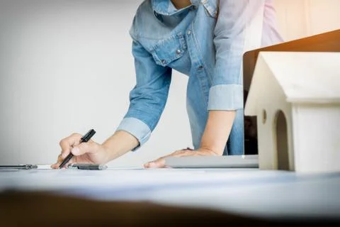 Close-up Of Person's engineer Hand Drawing Plan On Blue Print with architec.. Fotos de archivo