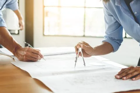 Close-up Of Person's engineer Hand Drawing Plan On Blue Print with architect Stock Photos
