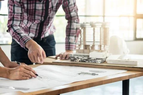 Close-up Of Person's engineer Hand Drawing Plan On Blue Print with architect Stock Photos