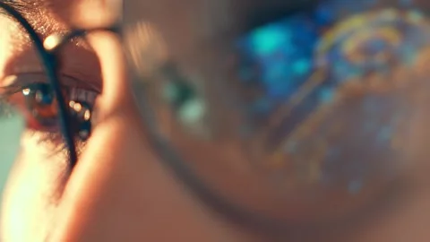 A close-up of a person’s eye in glasses reflecting a digital key. Stock Footage 317988152