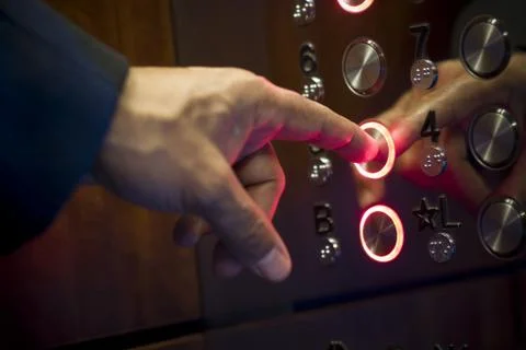 Close-up of a person's finger pressing a button of an elevator Stockfoto's