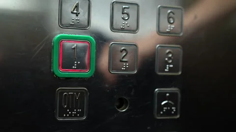Close-up of persons finger pressing first floor button on metal elevator panel. Stock Footage 342757191