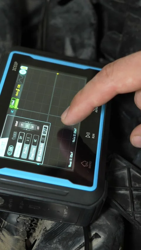 A close-up of a person's finger touching a portable digital oscilloscope scr Stock Footage 340334721