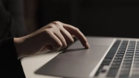 Close-up of a person's finger using a laptop touchpad for navigation and control Stock Footage 339173728