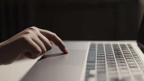 Close-up of a person's finger using a laptop touchpad for navigation and control Stock Footage 339173824