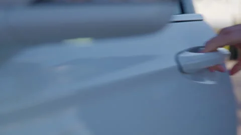 Close-up of a persons hand bringing the phone closer to the car handle and the Stock Footage 314308110
