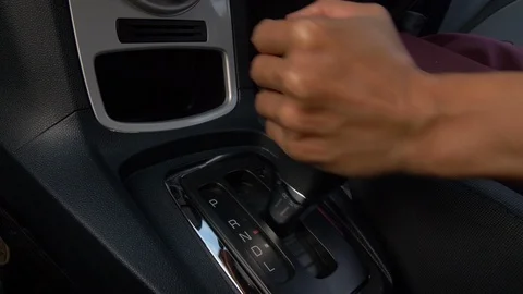 Close-Up Of Person's Hand Changing Gear While Driving Car Stock Footage 106048329