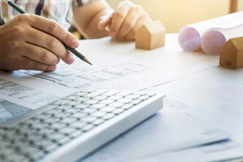 Close-up Of Person's Hand Drawing Plan On Blue Print with architect equipment Fotos de archivo