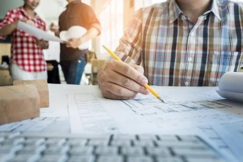 Close-up Of Person's Hand Drawing Plan On Blue Print with architect equipment Foto stock