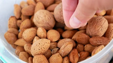 Close-up of a person's hand dry shelled almonds,shelled almonds, Stock Footage 167136688