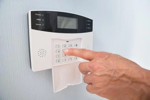 Close-up Of A Person's Hand Entering Code In Security System Stock Photos